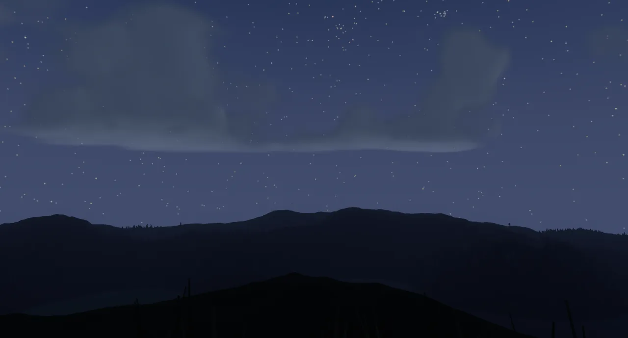 Stars and a thin band of cloud over dark forested hills.