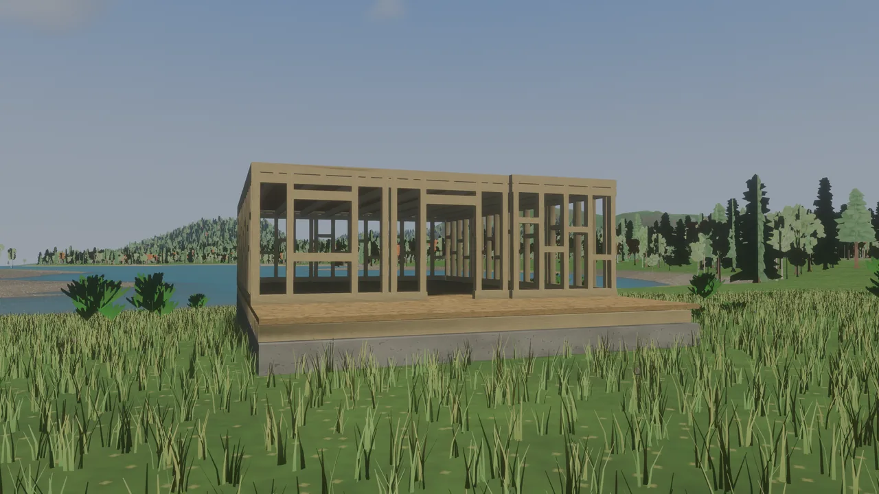 A wooden wall frame standing open on a floored foundation in a lakeside meadow, no walls on it yet.
